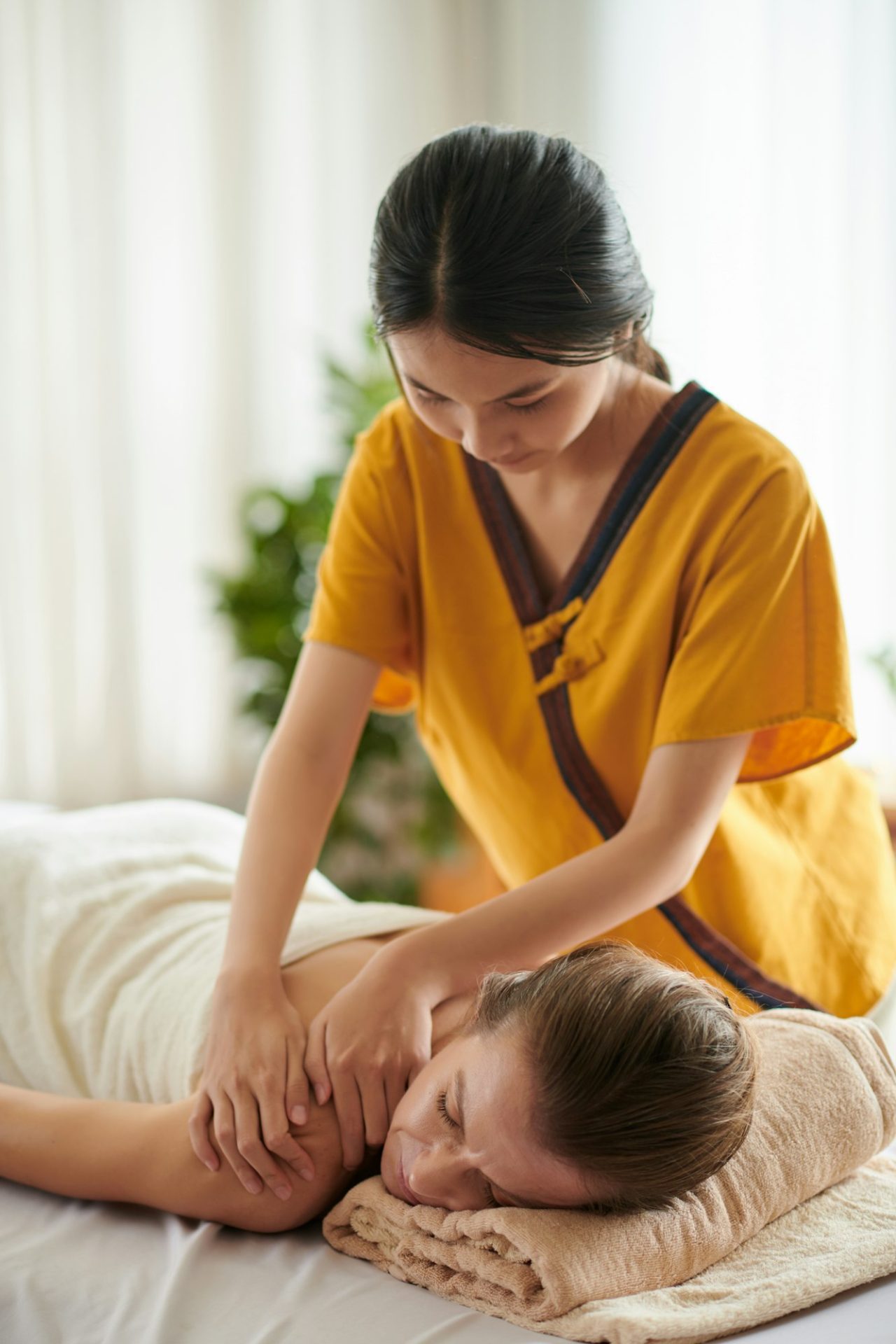Massaging Back Of Woman In Spa Salon.jpg